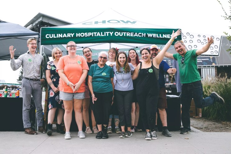 a group of people standing in front of a tent