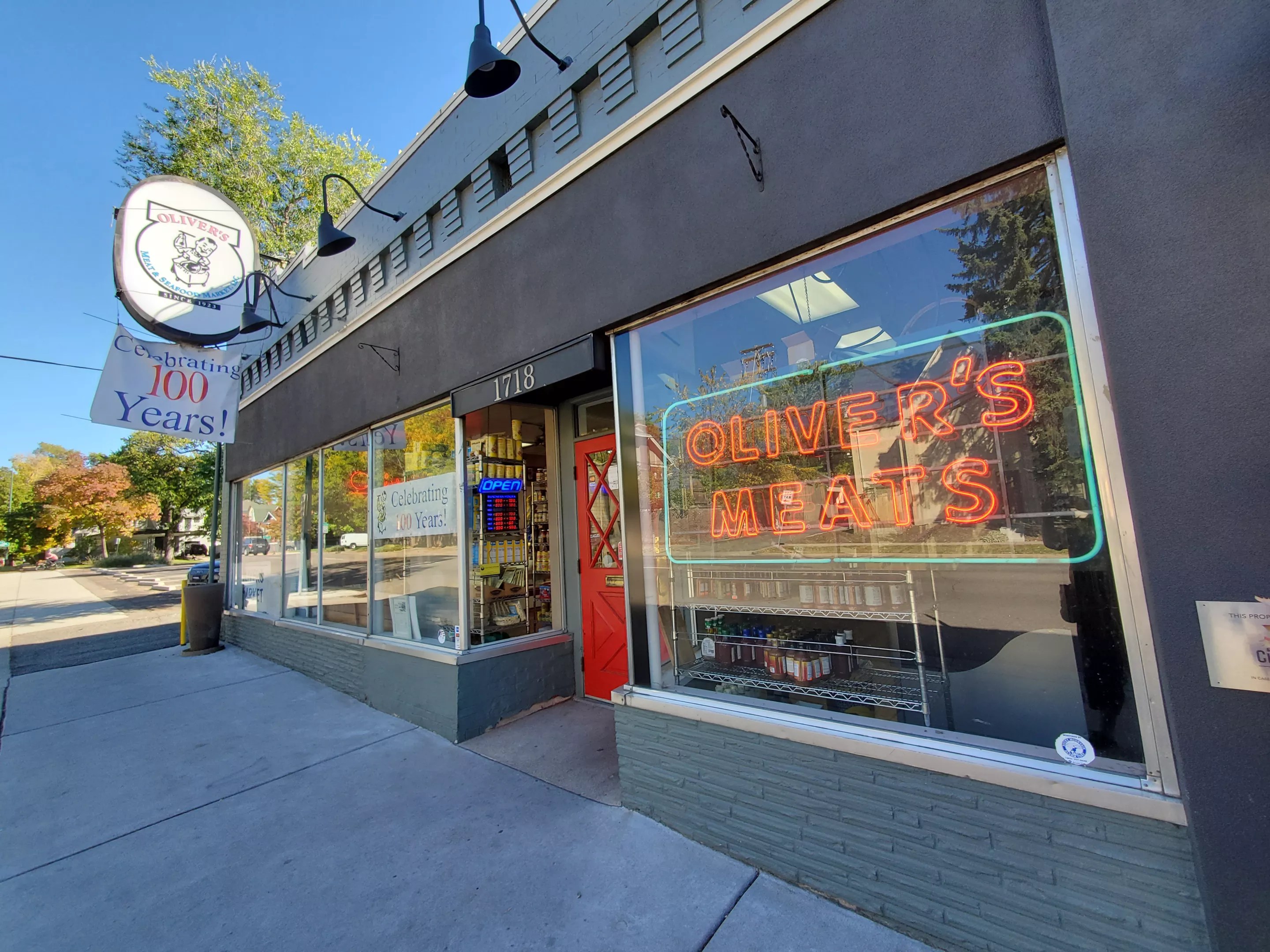 exterior of a shop with a neon sign in the window