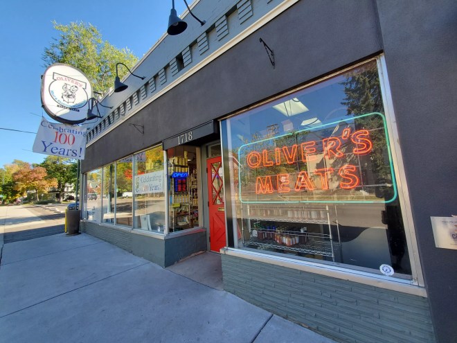 exterior of a shop with a neon sign in the window