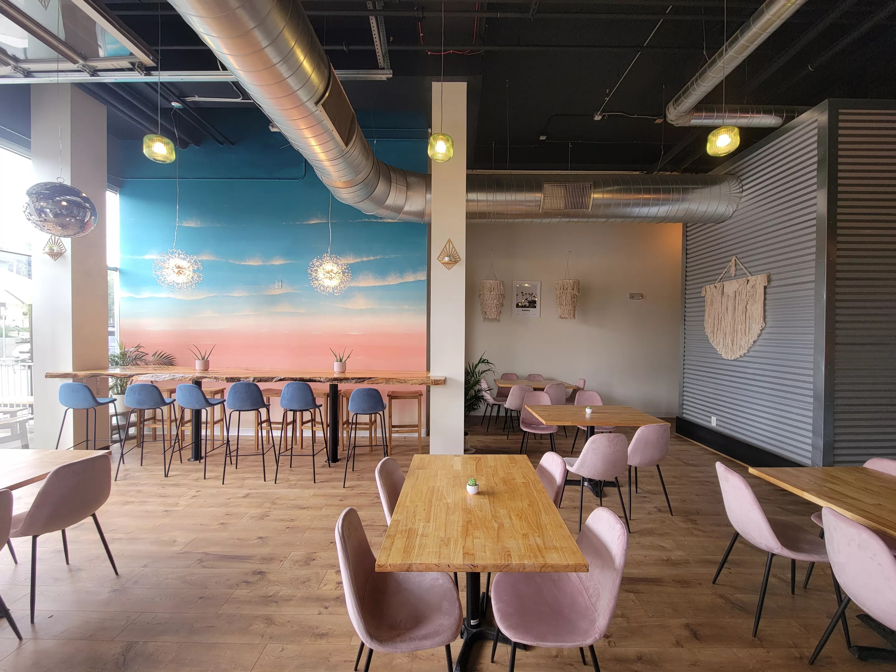 colorful dining room with chairs and mural
