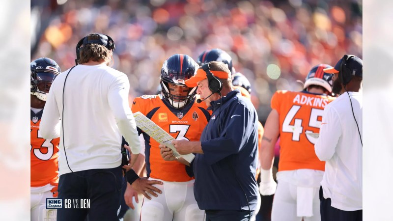 football player consults with coach