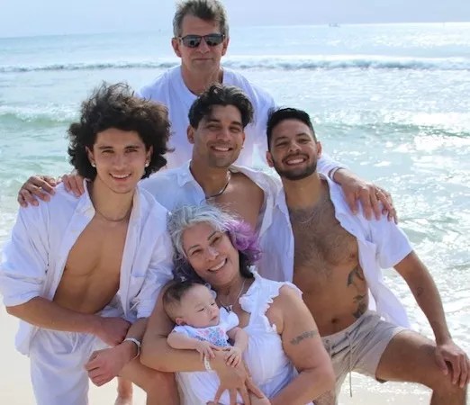 family on beach with baby