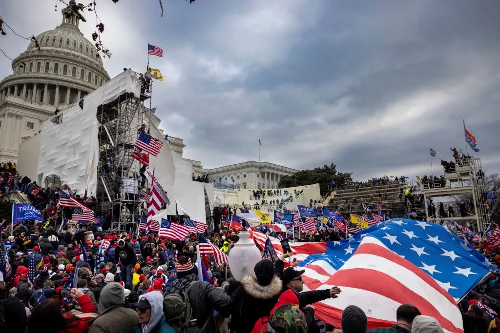 scene outside U.S. Capitol, flags, protesters