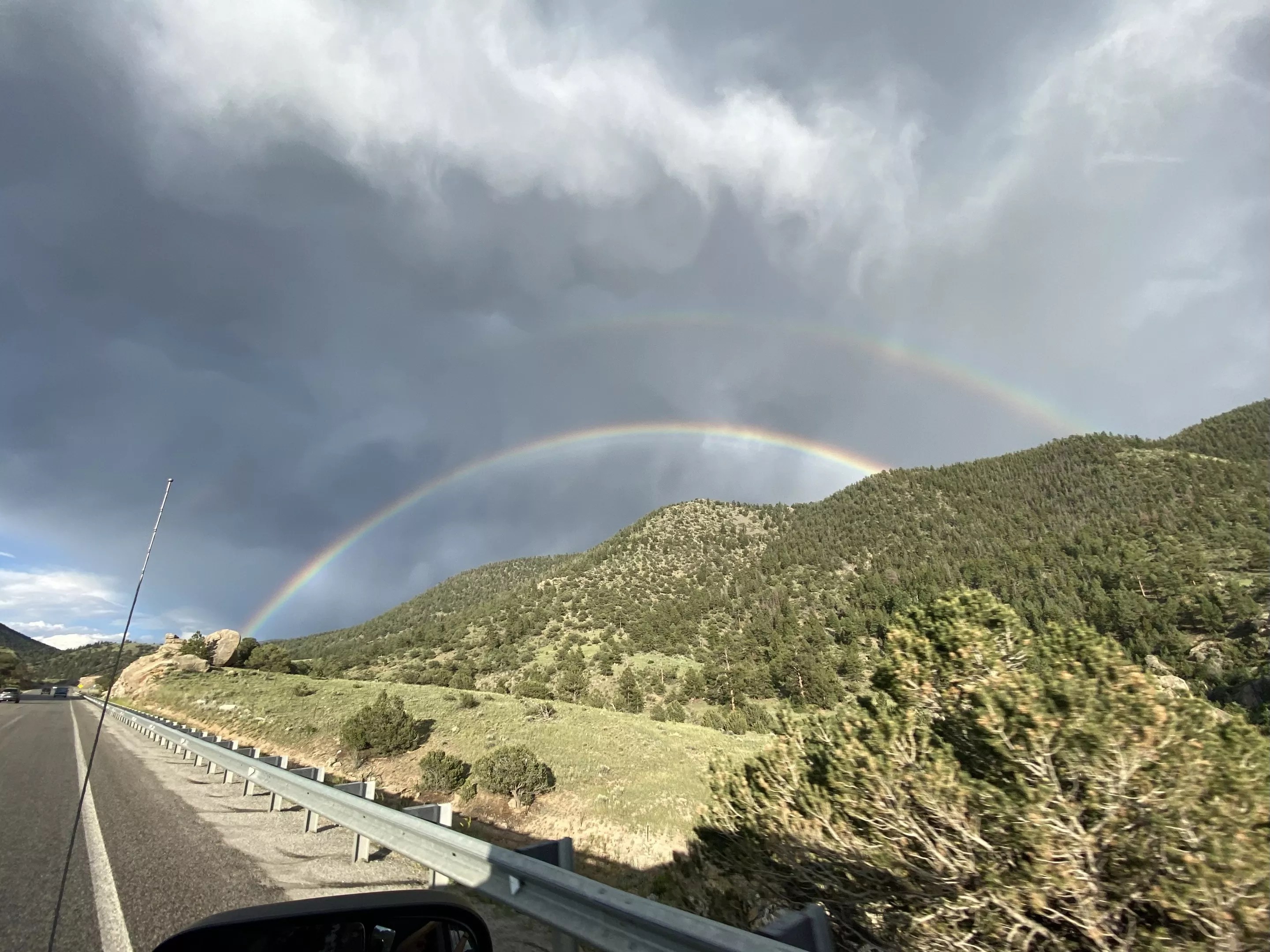 a double rainbow over mountains