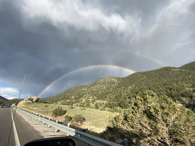 a double rainbow over mountains