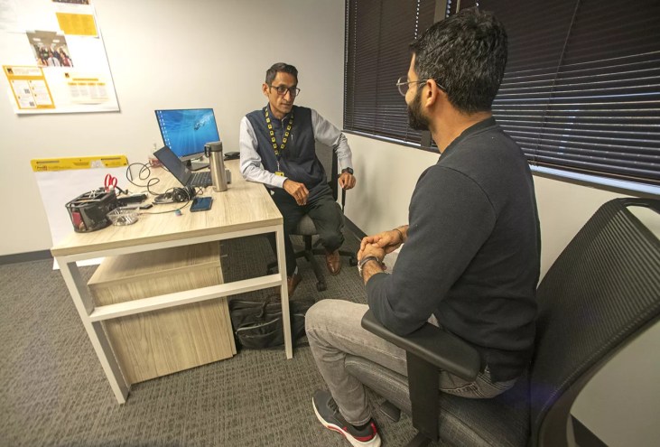 A refugee speaks to another refugee.