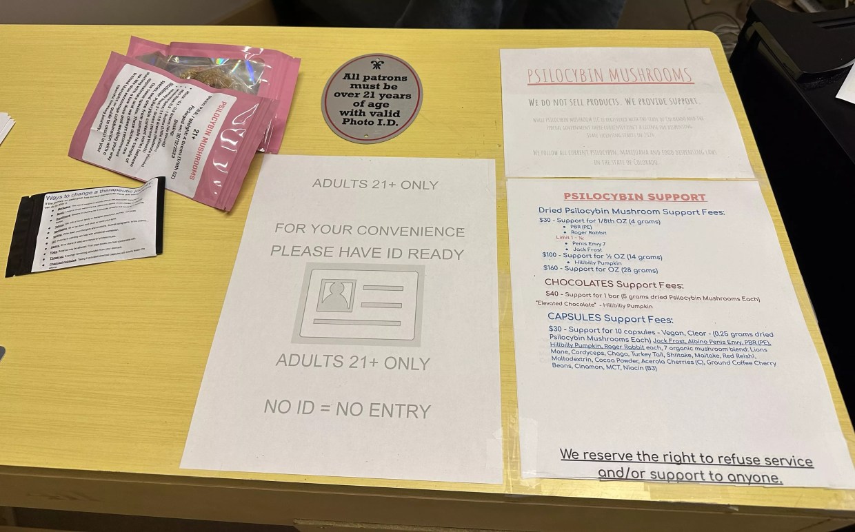 A menu and front desk at a magic mushroom co-op in Denver.