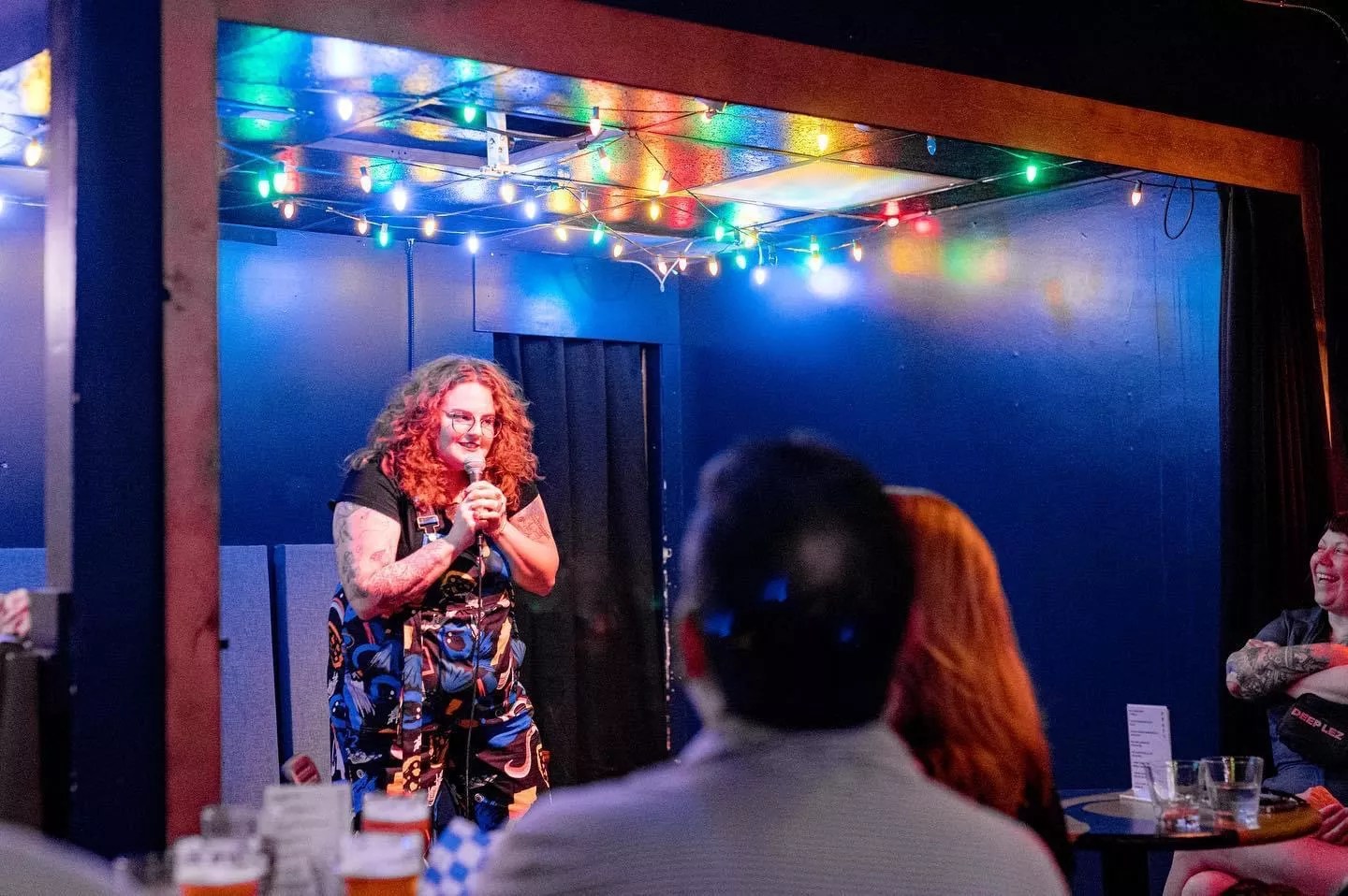 redhead woman comedian on stage