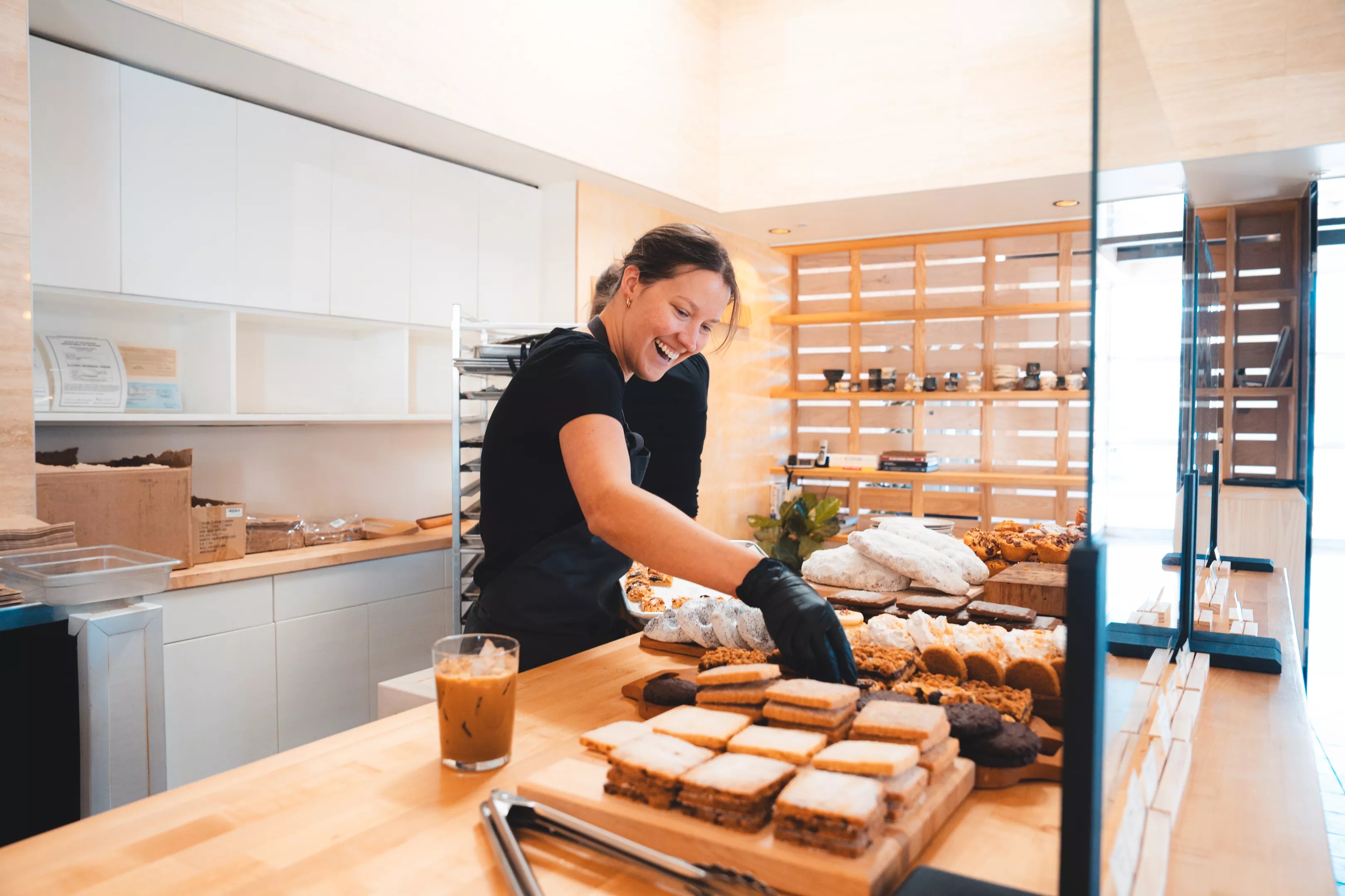 woman arranging pastries