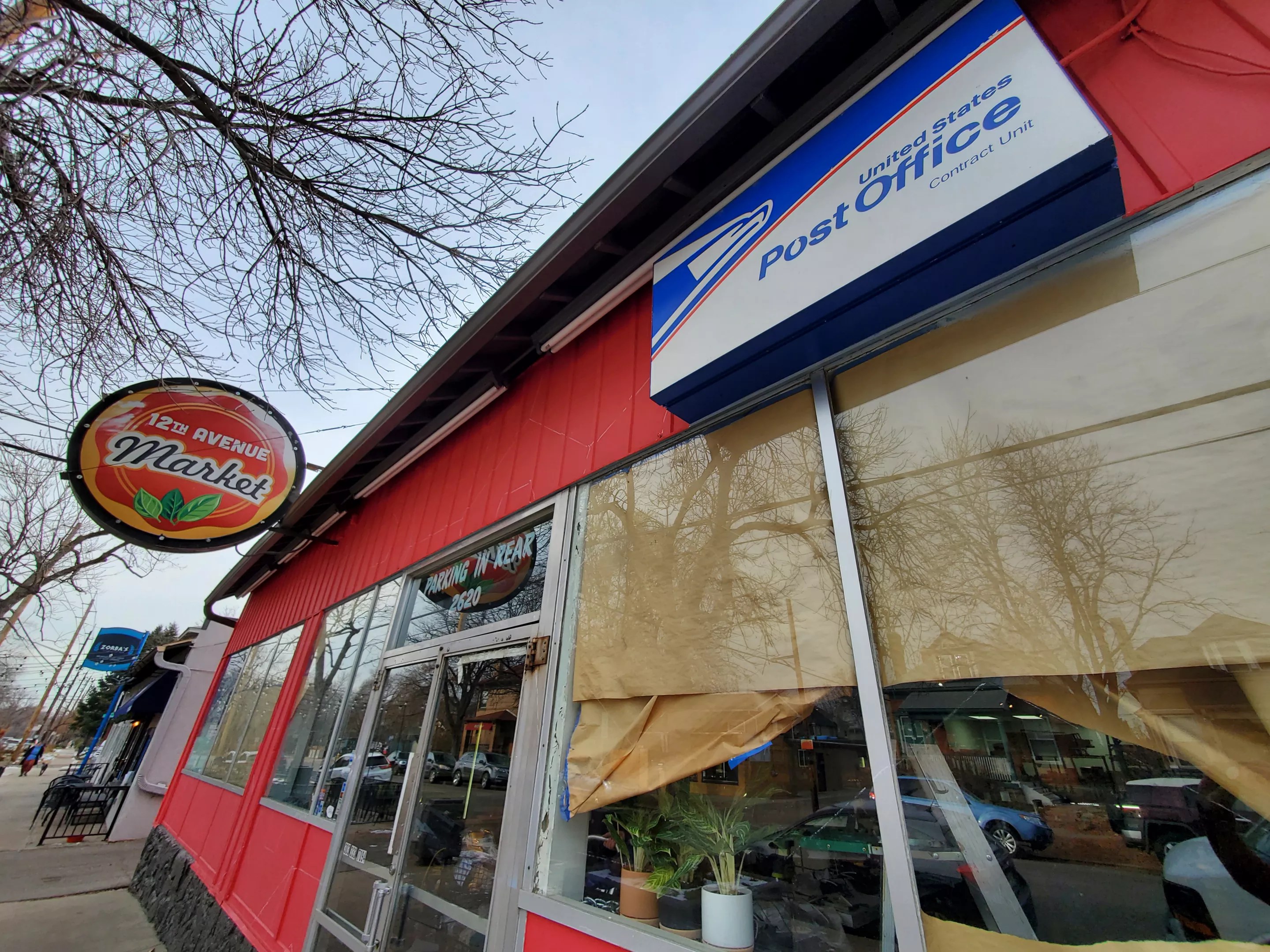 a post office sign on the front of a building