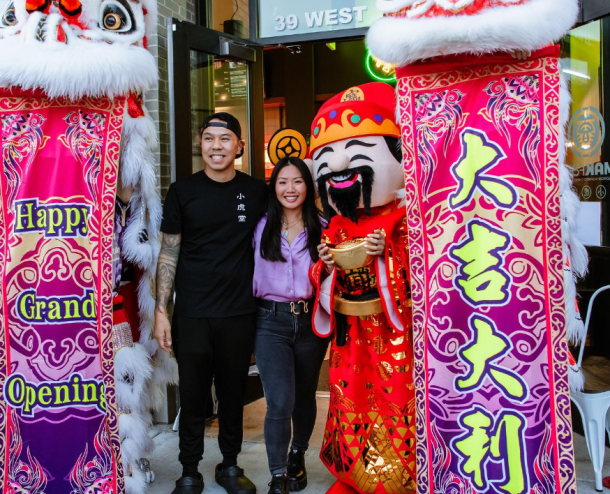 man and woman posting in front of colorful banners