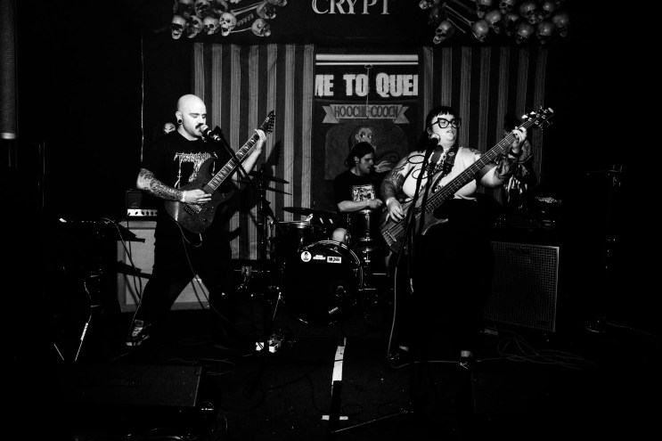 metal band poses for black and white photo