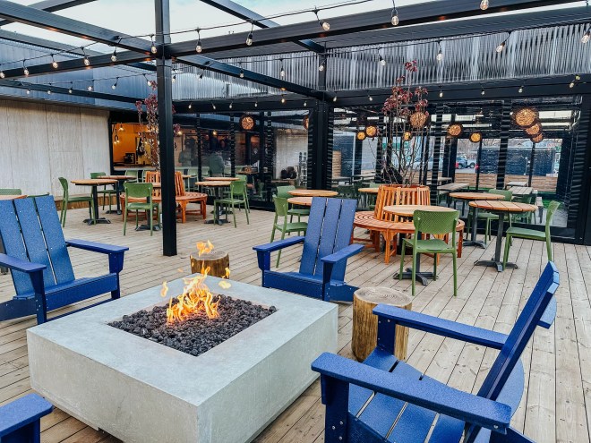 Outdoor patio at a brewery with a fire pit.
