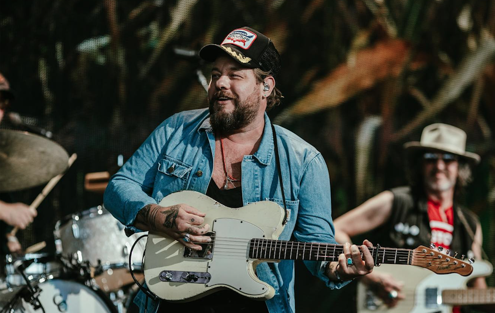 guitarist on stage wearing a hat