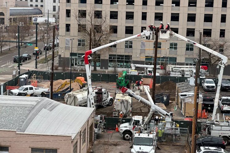 Workers toy with the wiring at the micro-community at the 1375 Elati Street.