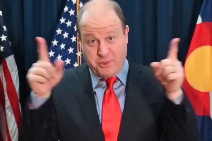 man in suit gesturing