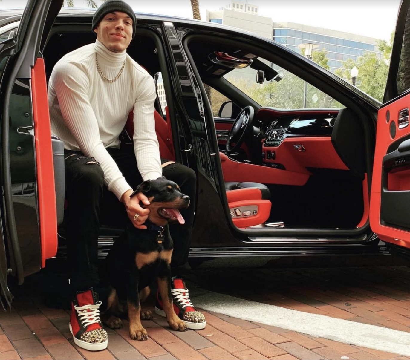 Denver Nuggets star Aaron Gordon posing with his dog.