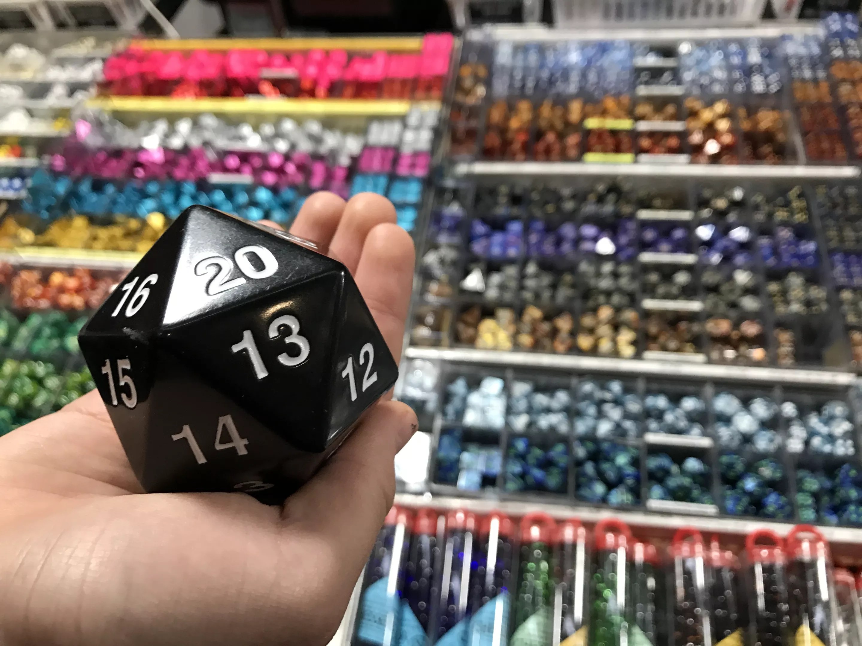 person holding a 20-sided dice