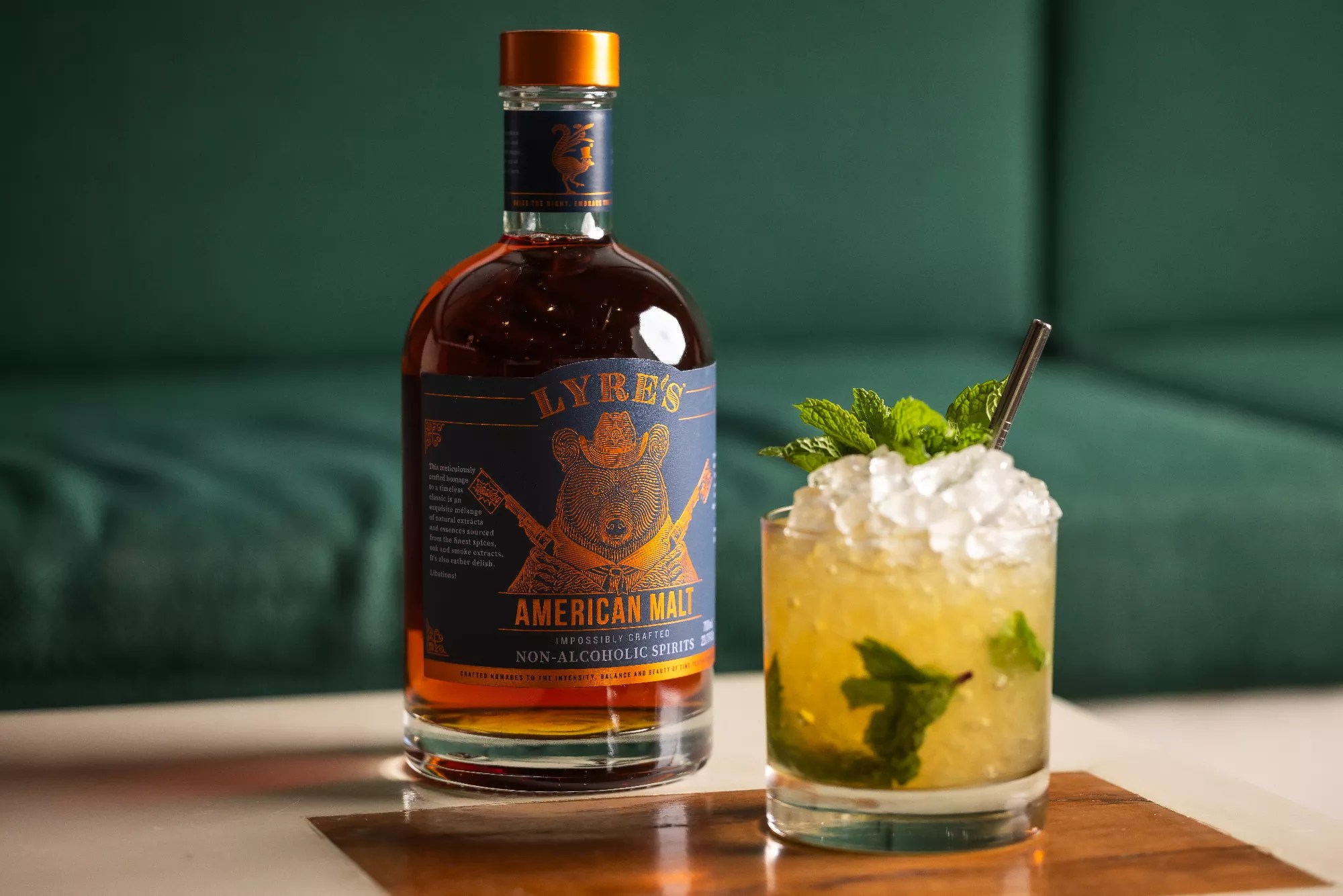 a bottle next to a cocktail in a glass