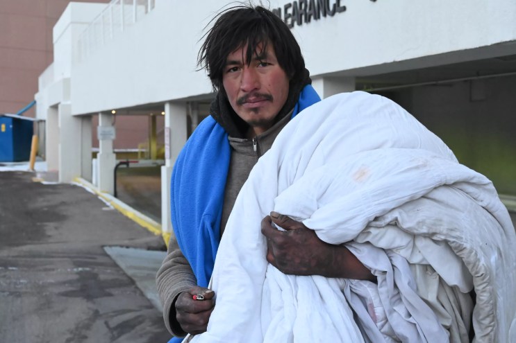 A homeless resident looks for a warm place to sleep.