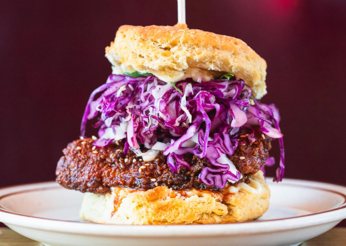 a biscuit sandwich with fried chicken and cabbage