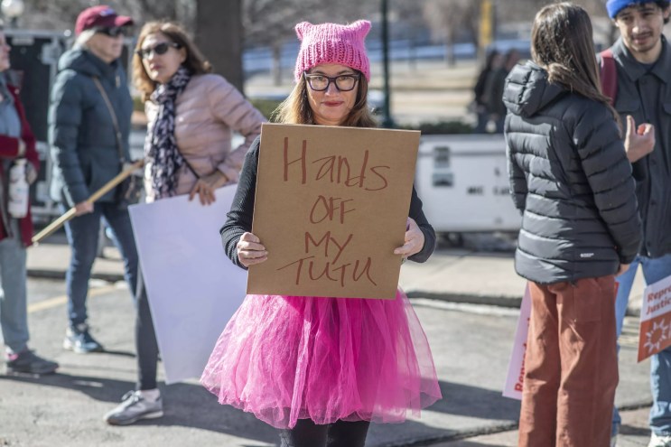 woman in pink tutu and hat with sign supporting abortion