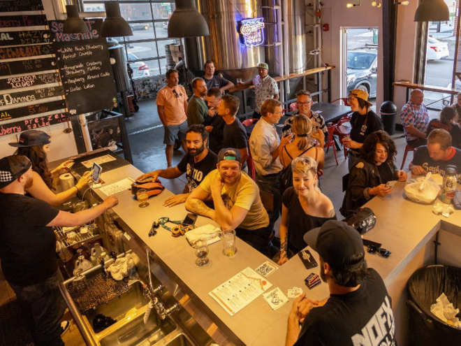 people in a brewery taproom