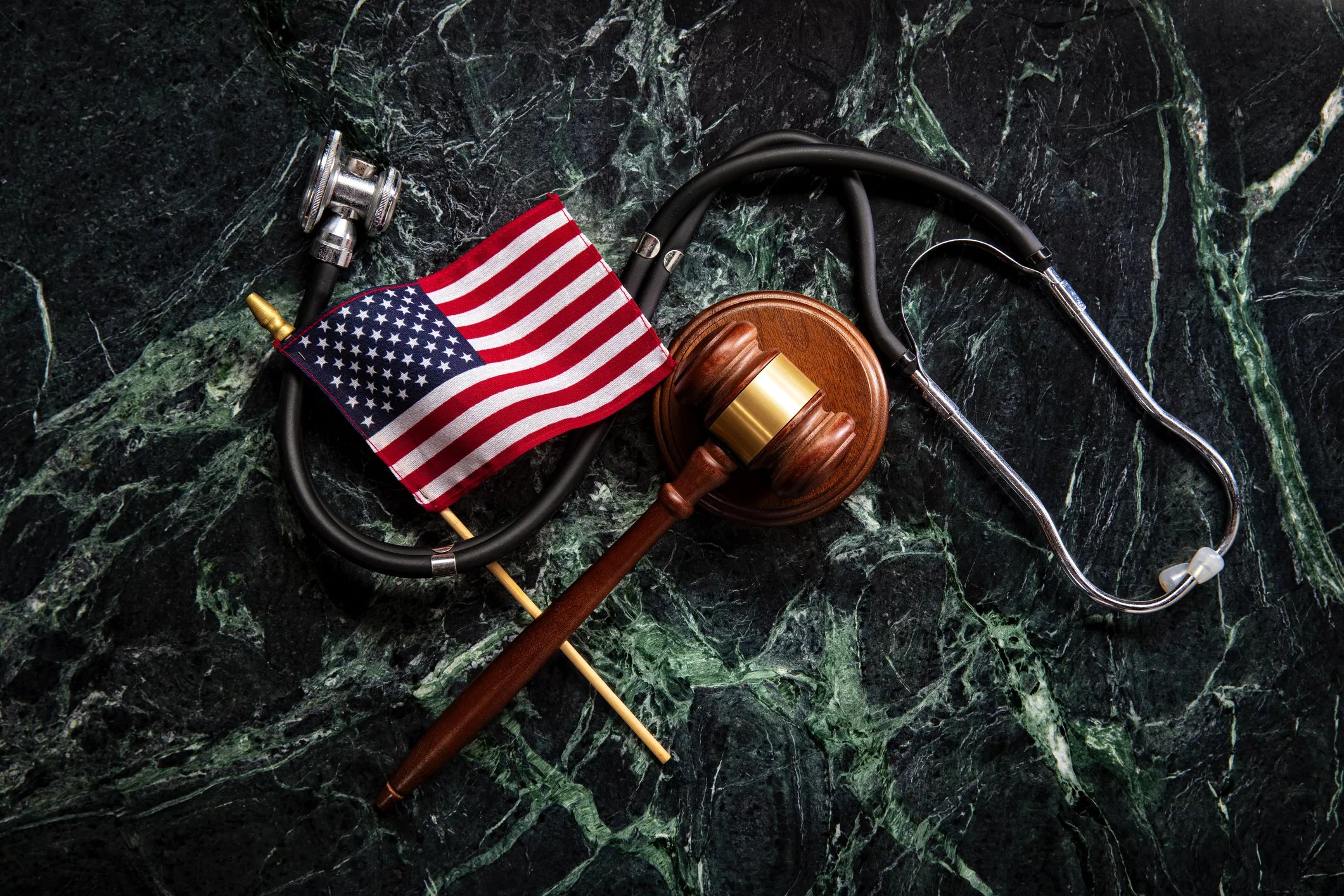 flag, stethoscope and gavel on marblebround