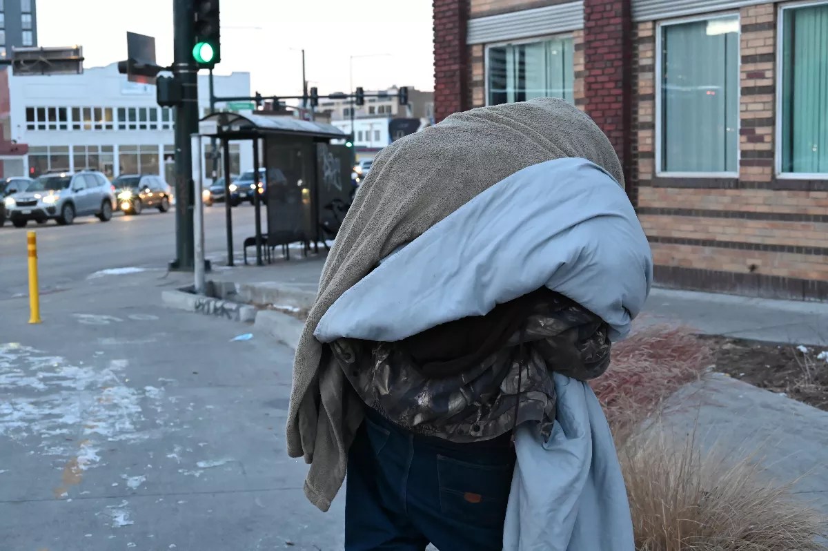 Homeless resident Josh Rush looks for a place to get warm.
