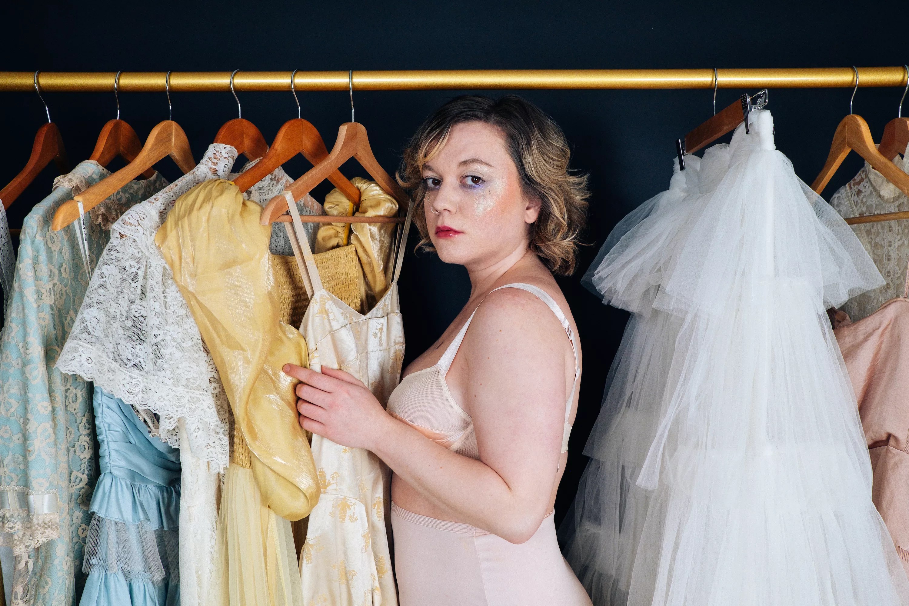 woman looking at clothes in a closet