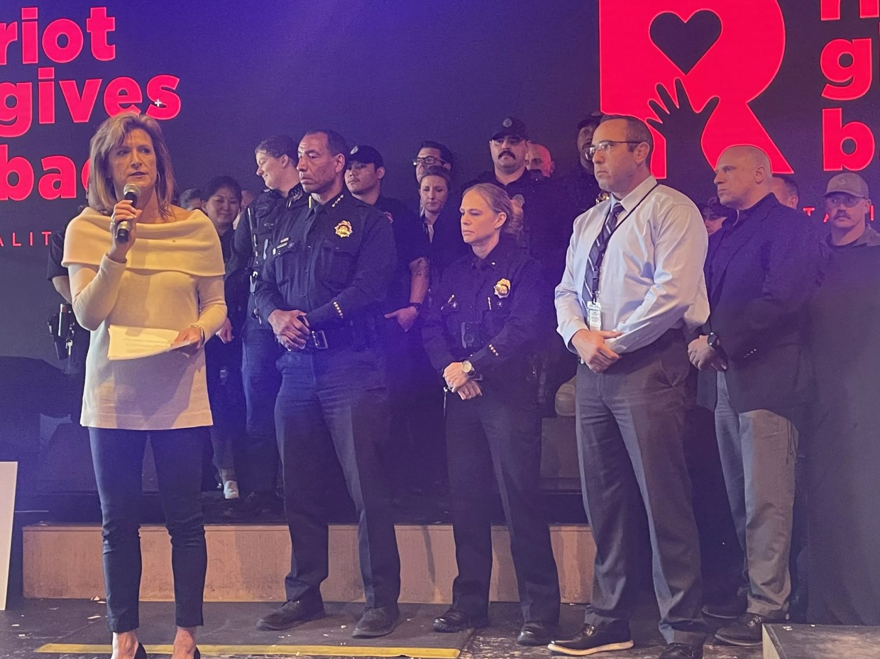 Police stand on a stage