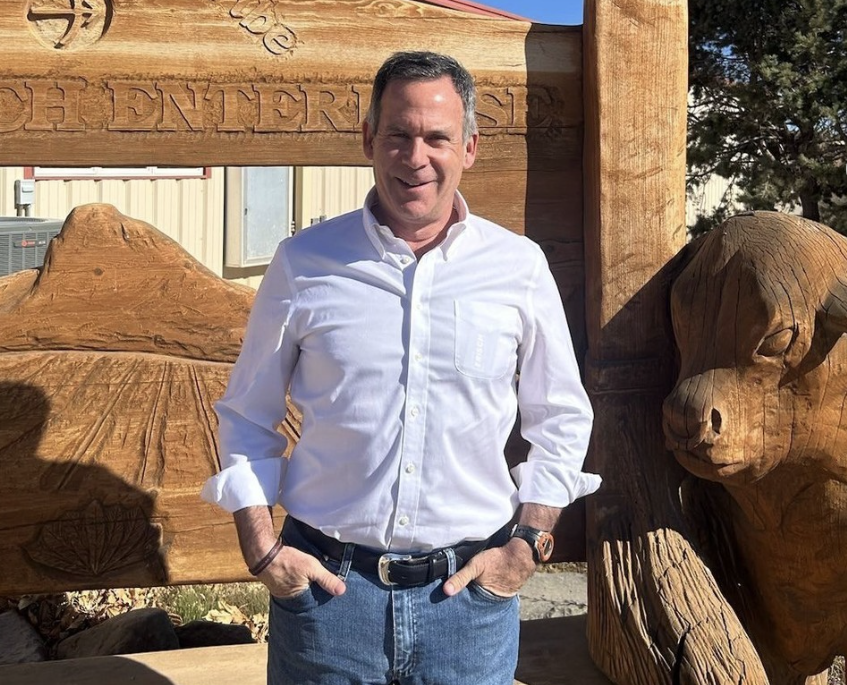 Adam Frisch smiling for a photo.