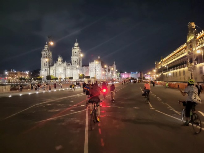 A man rides a bike through Mexico City