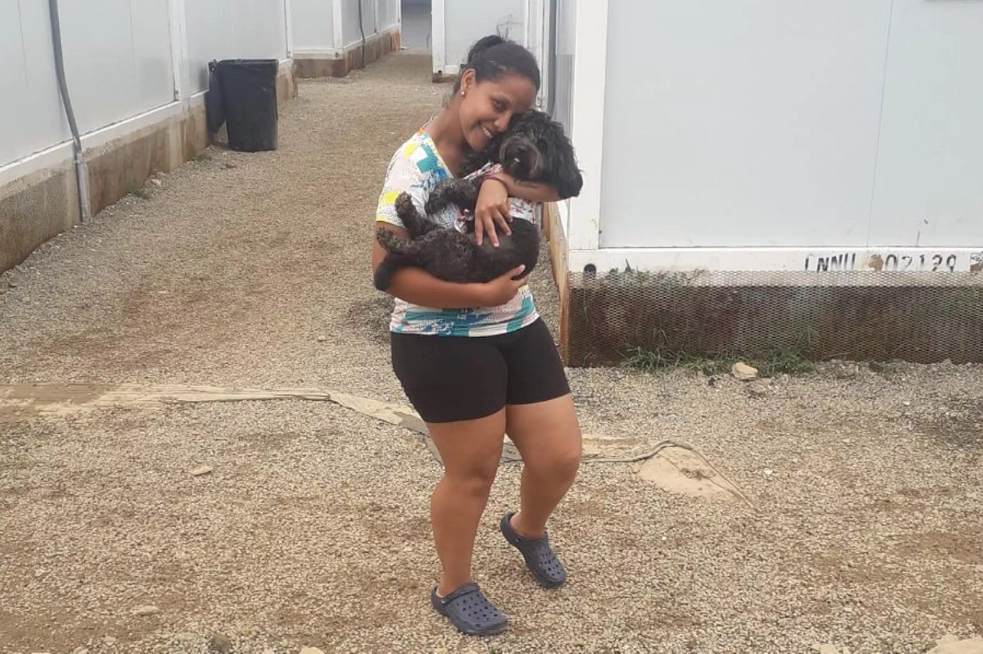 Venezuelan migrant Rosemely Perez embraces her dog.