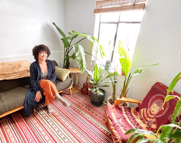 woman sitting in a room with plants