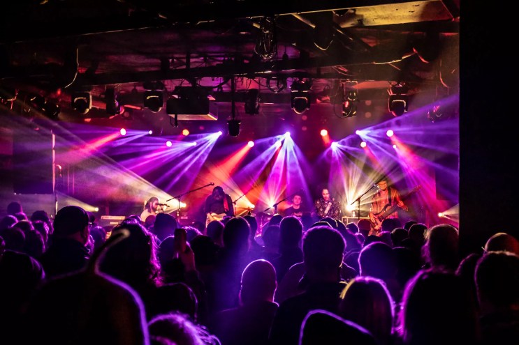 jam band on stage with purple lights