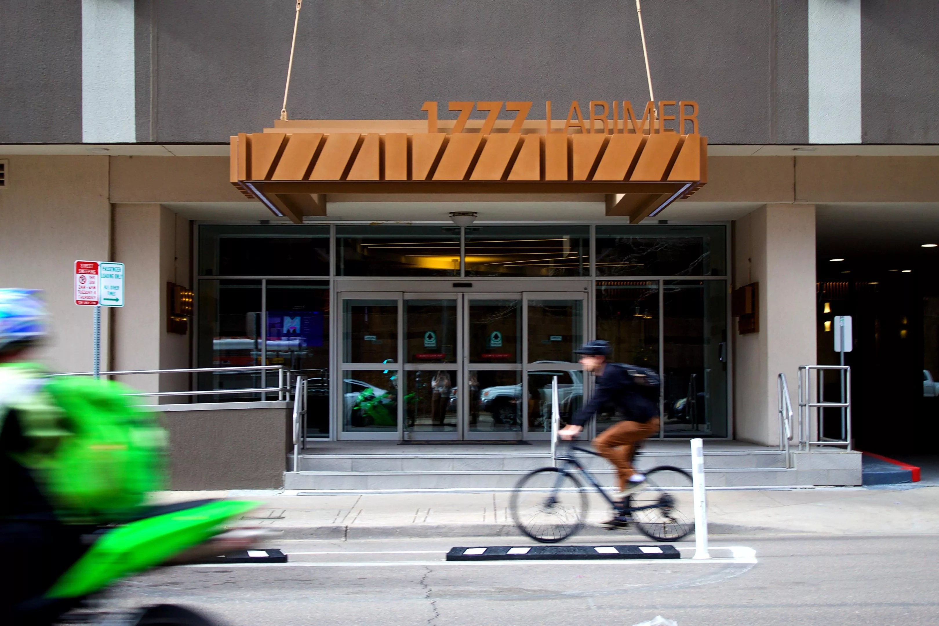 A bicyclist riding by the Windsor Condos at 1777 Larimer Street.