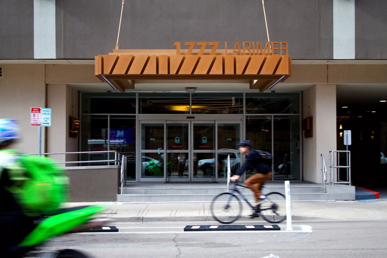 A bicyclist riding by the Windsor Condos at 1777 Larimer Street.