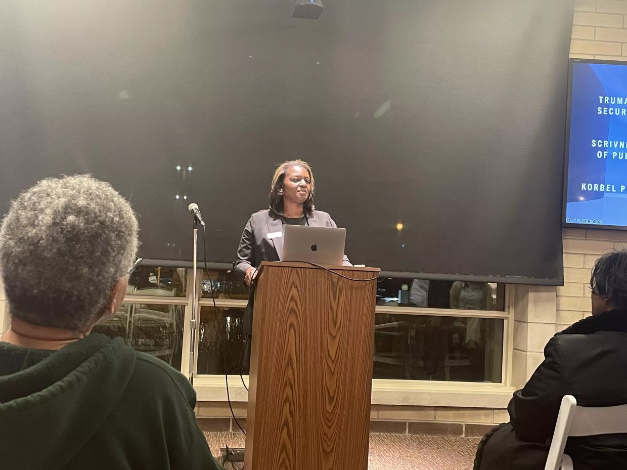 A woman stands at a podium.