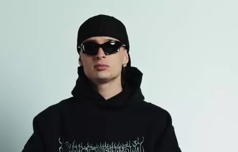 man in sunglasses, black hat and sweatshirt
