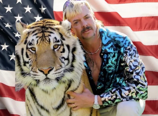 tiger and man in front of flag