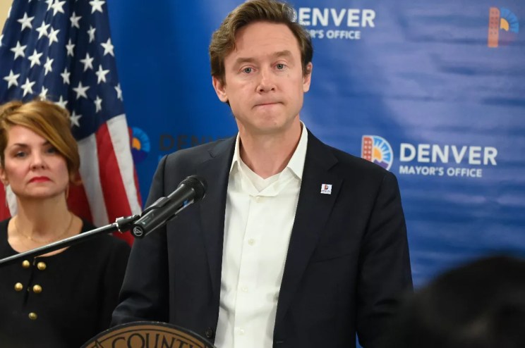 Mayor Mike Johnston stands with Councilwoman Amanda Sandoval behind him.