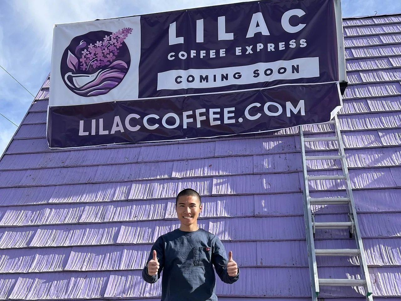 a man standing in front of a purple building
