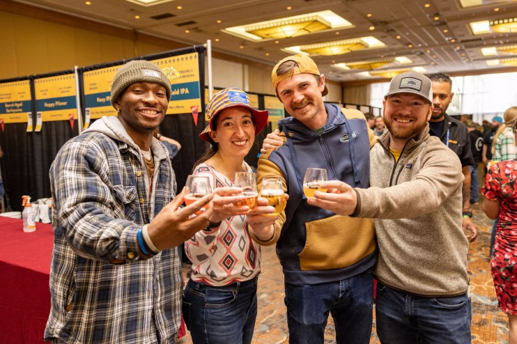 Four people with beers.