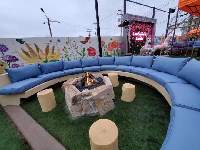 a fire pit in front of a blue couch