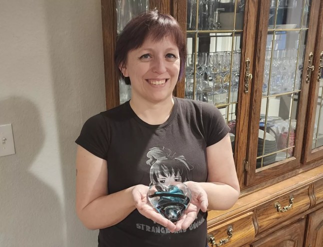 woman holding a glass art piece