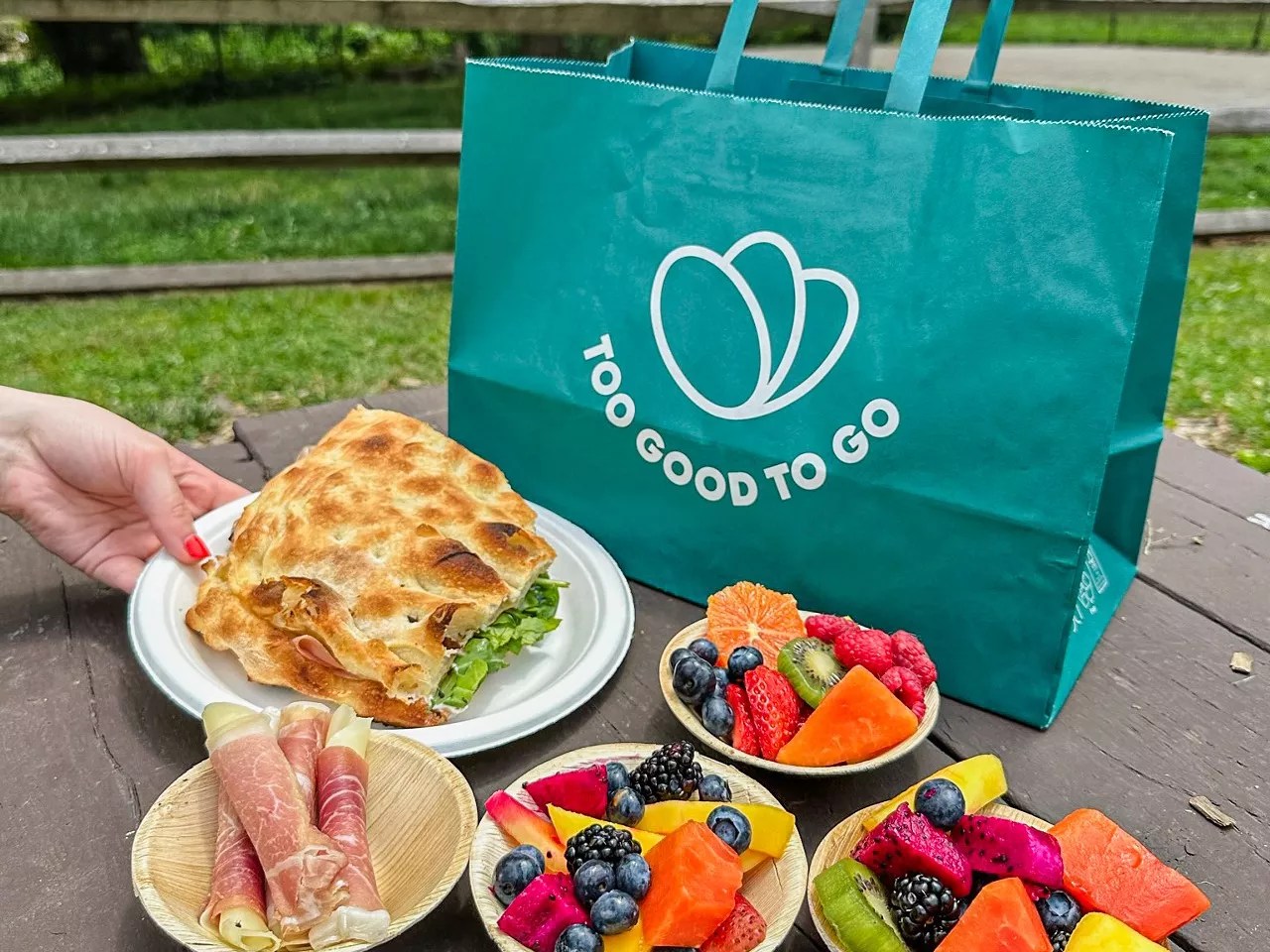 various food on plates in front of a green bag