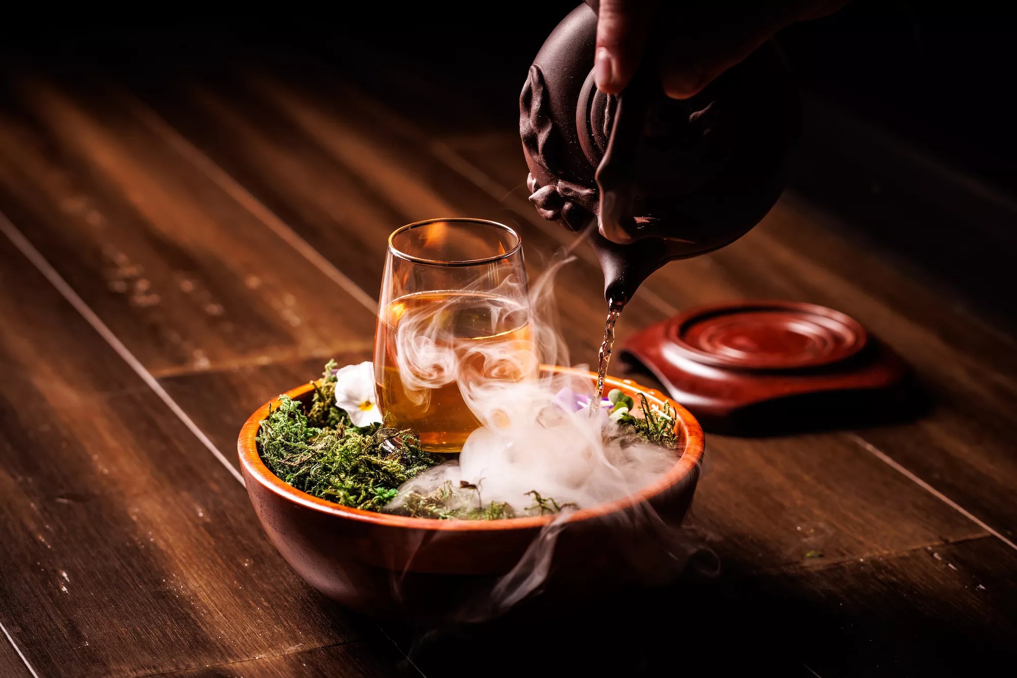 cocktail on a bed of moss with mist