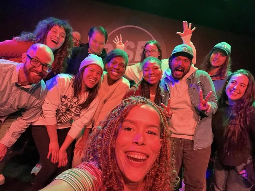 group of comics with girl in front.