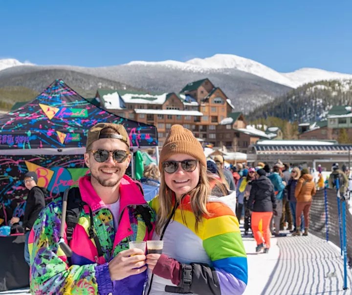 man and woman in ski clothes with beer